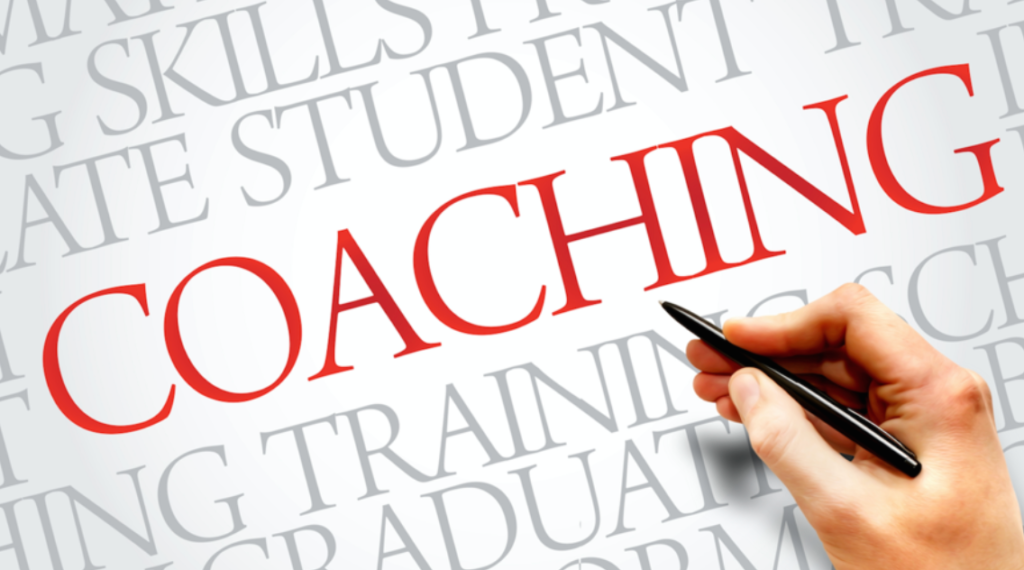 A hand hovers over the word coaching.