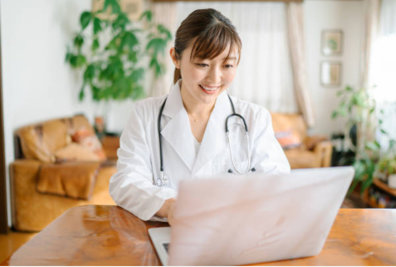 Asian female physician using a computer