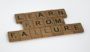 Scrabble letter blocks spell out Learn from failure, which is the goal when mastering multiple choice questions during your board exam prep.